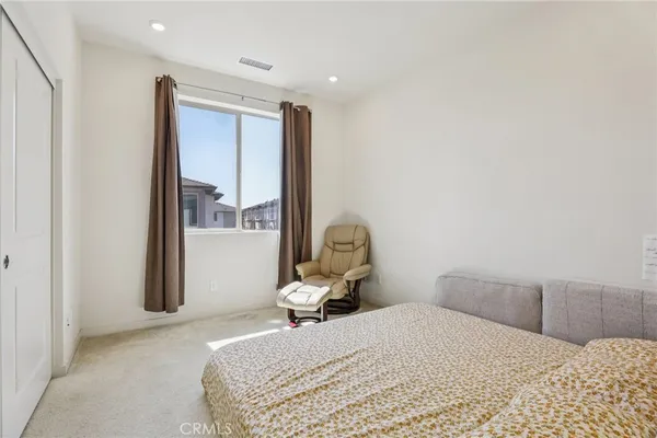 a bedroom with a bed and mirror