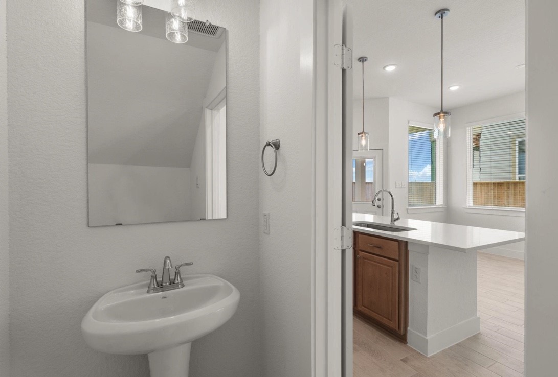 5234 Capricorn Way Manvel, TX 77578 - Photo 7 of 25 a bathroom with a sink and a mirror