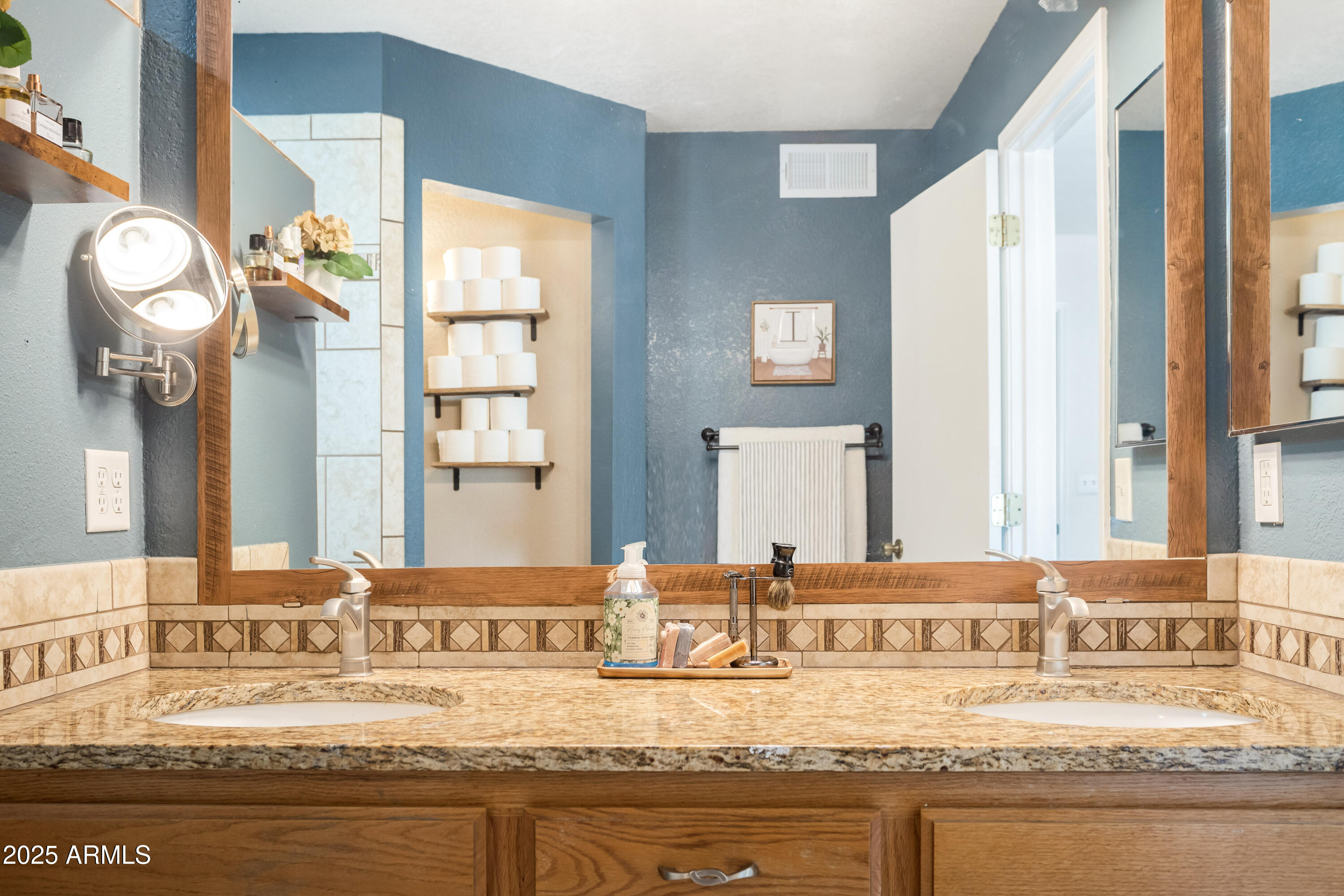 4931 Loma Loop Sierra Vista, AZ 85635 - Photo 27 of 47 a bathroom with a granite countertop sink and a mirror