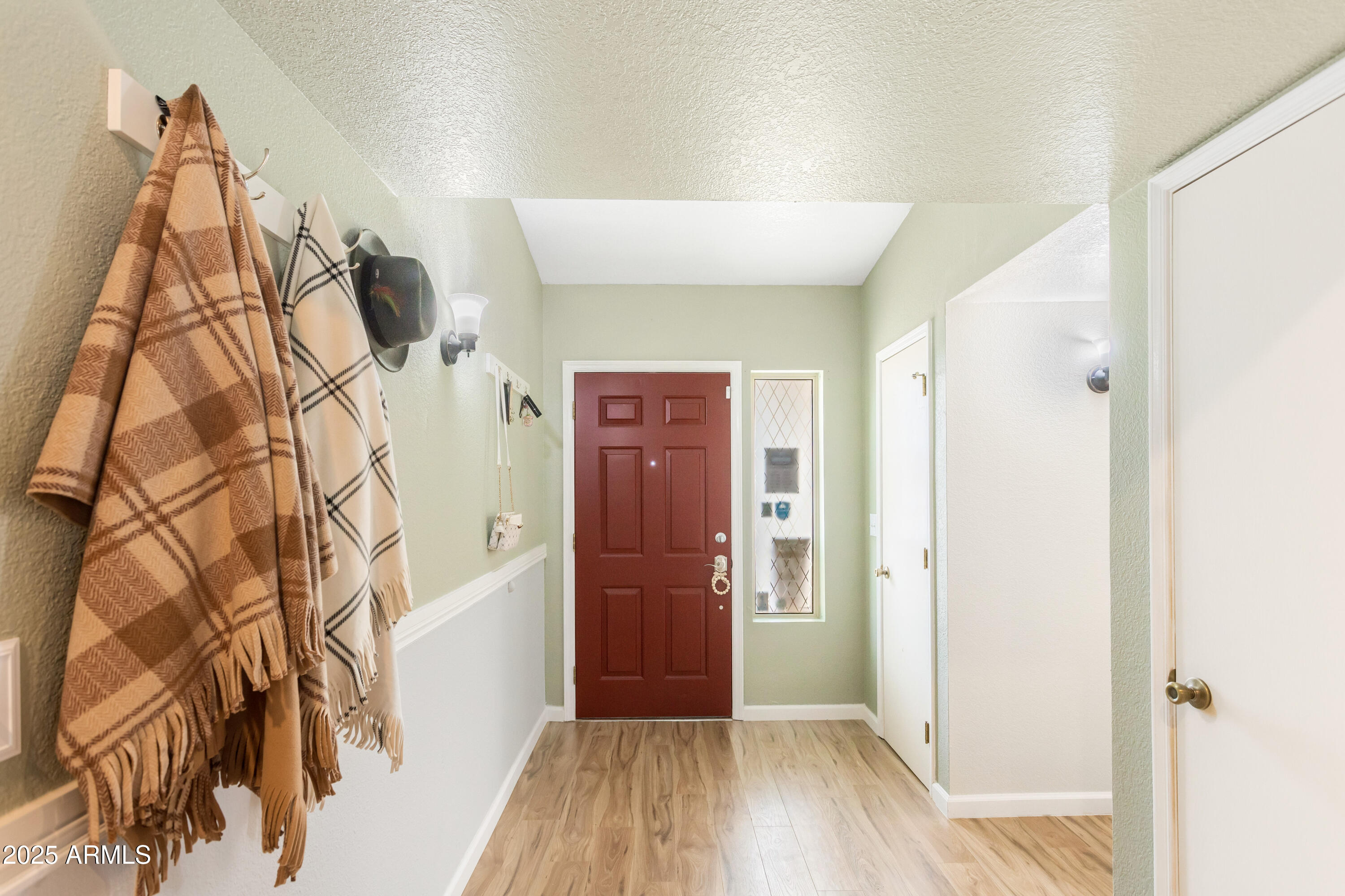 4931 Loma Loop Sierra Vista, AZ 85635 - Photo 4 of 47 a view of a hallway with wooden floor and entryway