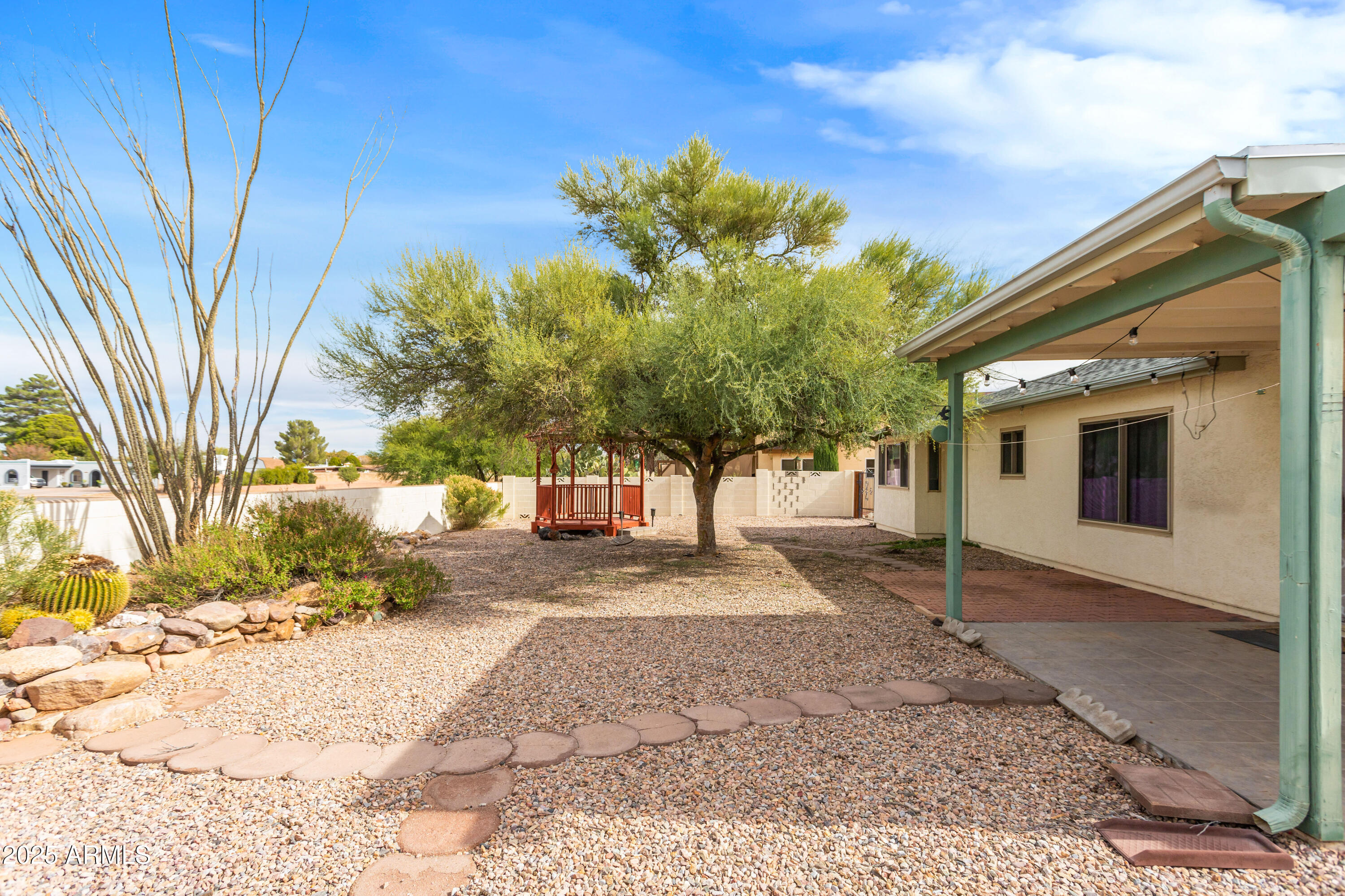 4931 Loma Loop Sierra Vista, AZ 85635 - Photo 45 of 47 a view of a grey house with a yard