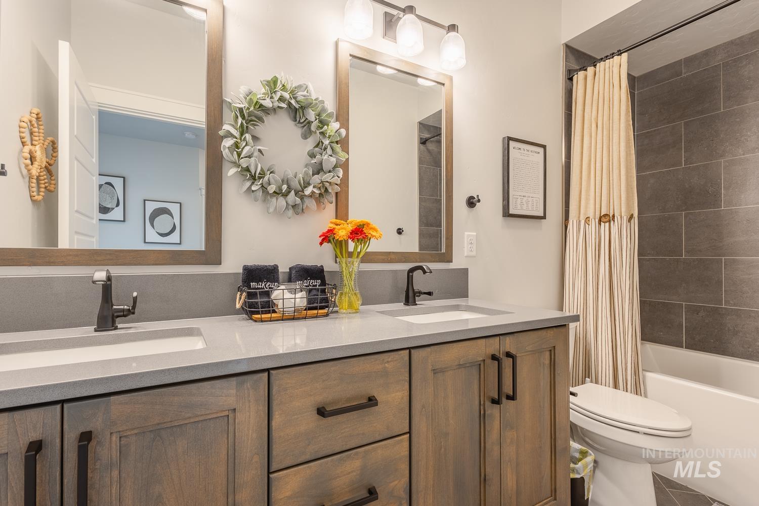 3321 South Hopes Well Way Boise, ID 83716 - Photo 35 of 40 Full bath with double vanity, shower / bath combo with shower curtain, and tile patterned floors