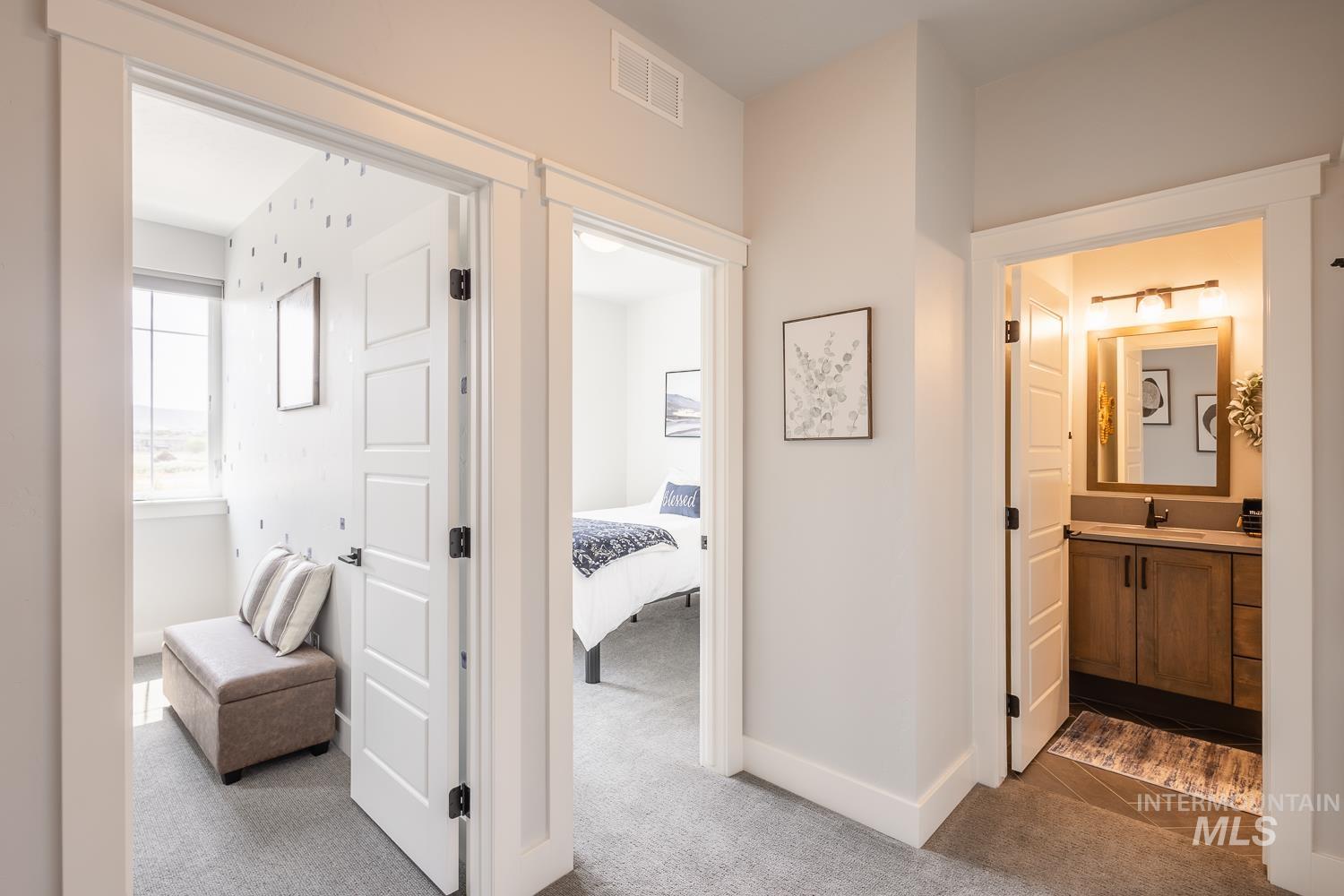 3321 South Hopes Well Way Boise, ID 83716 - Photo 37 of 40 Corridor with dark colored carpet and baseboards