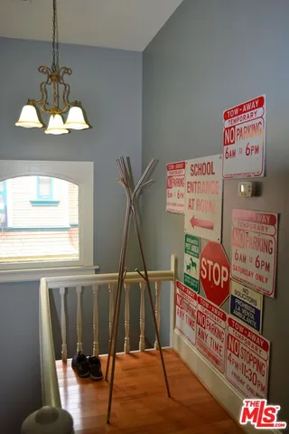a view of a room with furniture wooden floor chandelier