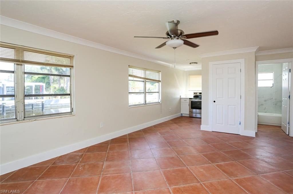 2777 Shoreview Drive, Unit 2 Naples, FL 34112 - Photo 7 of 8 Tiled spare room featuring crown molding and ceiling fan