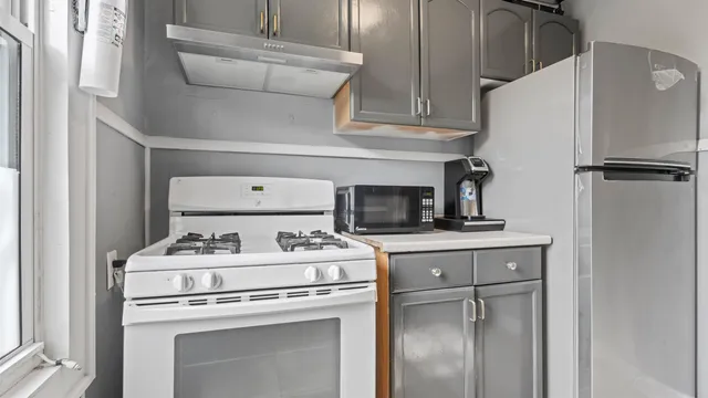 a kitchen with a stove top oven and cabinets