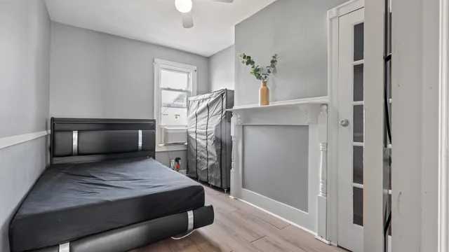 a bedroom with a bed and a window