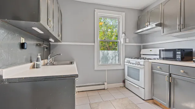 a kitchen with a sink cabinets and appliances