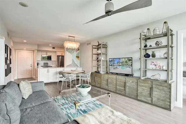 a living room with furniture a fireplace and a table