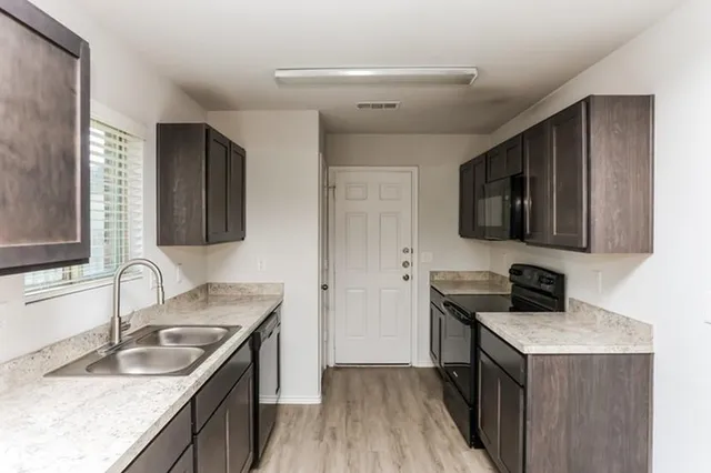 a kitchen that has a sink and a stove in it