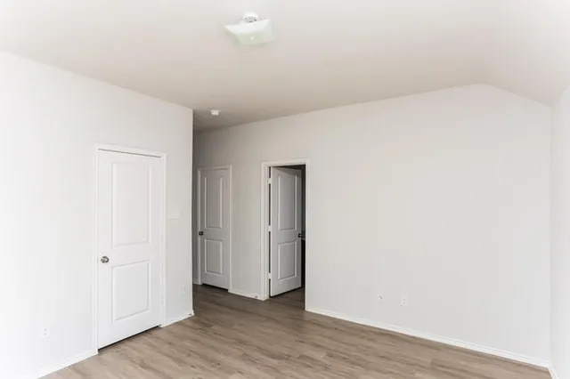 a view of hallway with wooden floor