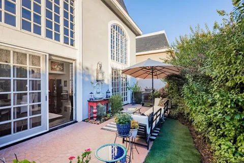 a view of a patio with table and chairs and potted plants
