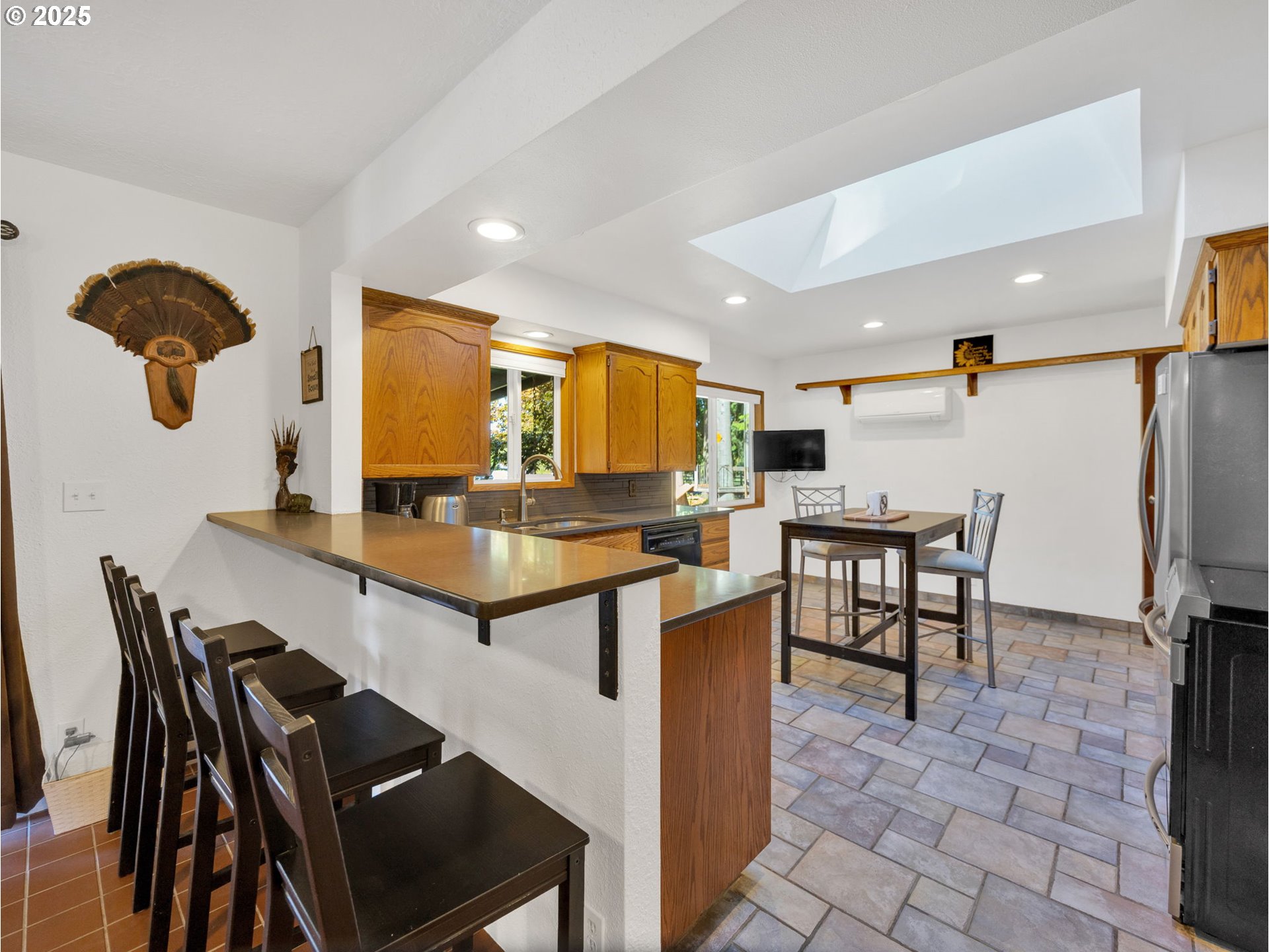44434 Southeast Coalman Road Sandy, OR 97055 - Photo 27 of 48 a kitchen with stainless steel appliances granite countertop a table chairs and a refrigerator