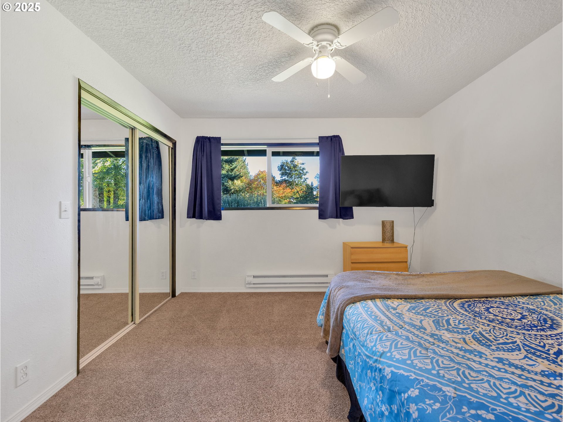 44434 Southeast Coalman Road Sandy, OR 97055 - Photo 32 of 48 a bedroom with a bed and a flat screen tv