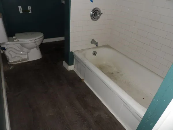 a bathroom with a bathtub and toilet