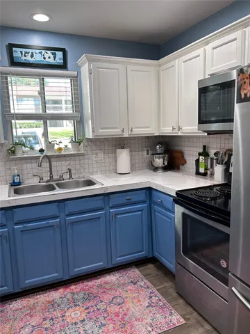 a kitchen with stainless steel appliances granite countertop a sink stove and microwave