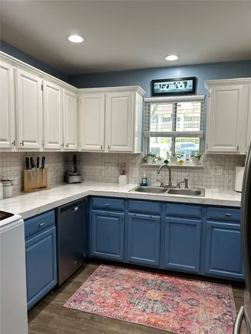 a kitchen with stainless steel appliances granite countertop a sink and cabinets
