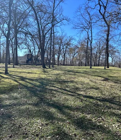 a big yard with lots of green space and trees