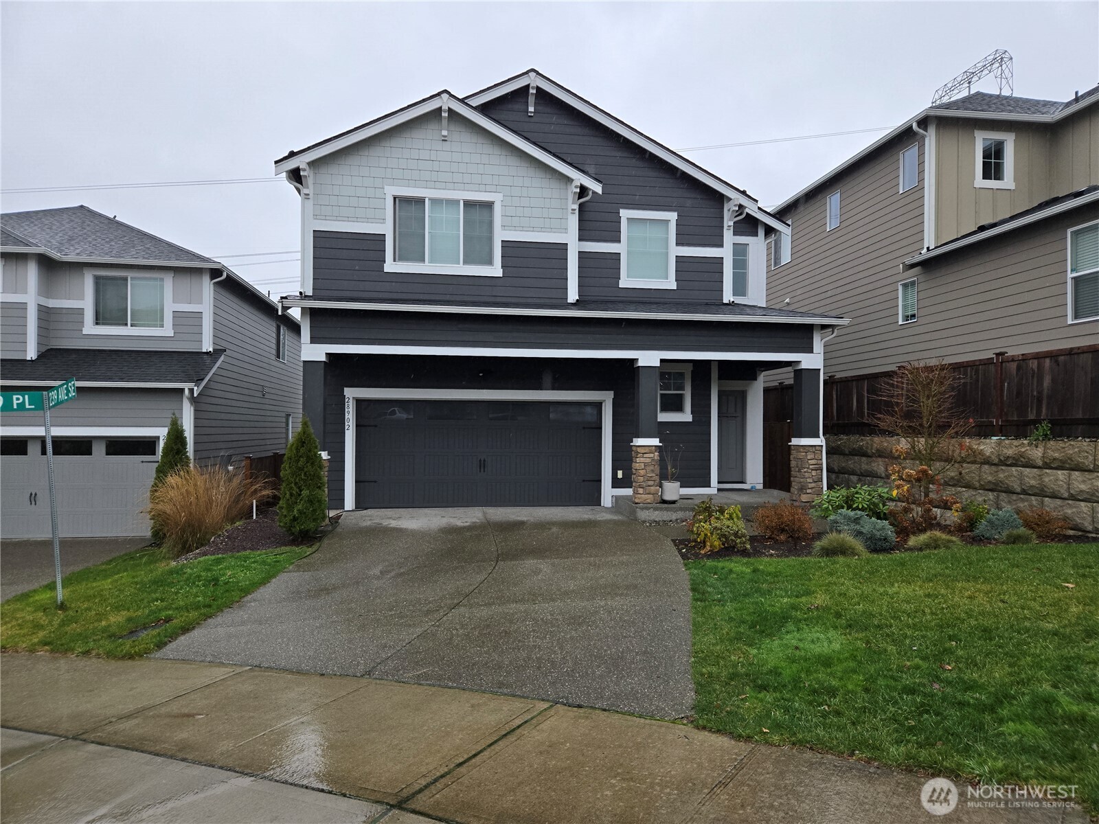 28902 239th Avenue Southeast Maple Valley, WA 98010 - Photo 1 of 22 a front view of a house with a yard and garage