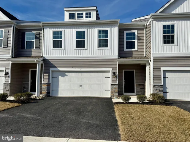 a view of a brick house with many windows