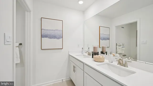 a bathroom with 2 sink and a mirror