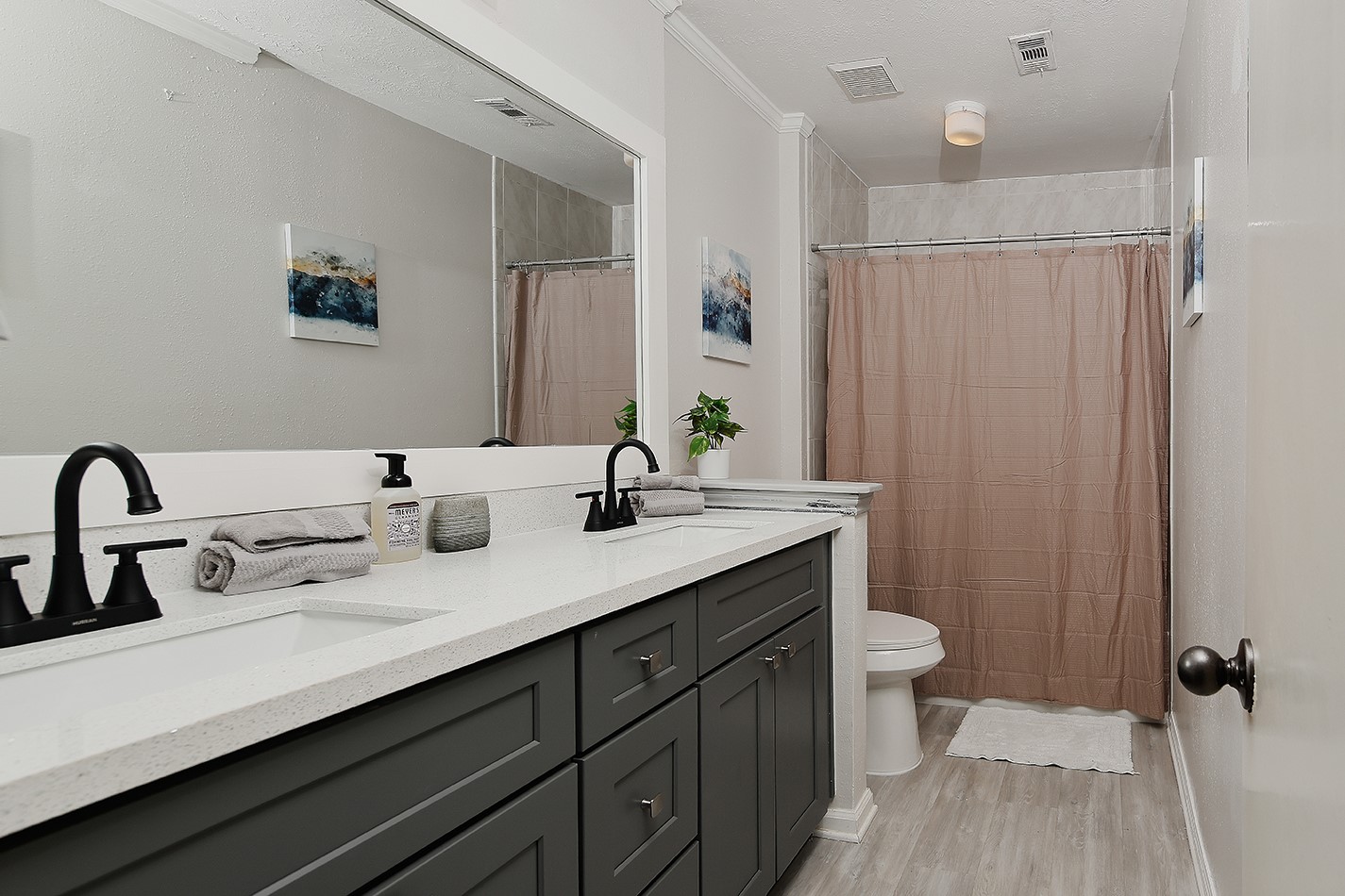 99 North Deerfoot Circle Spring, TX 77380 - Photo 15 of 22 a bathroom with a double vanity sink a toilet and a mirror