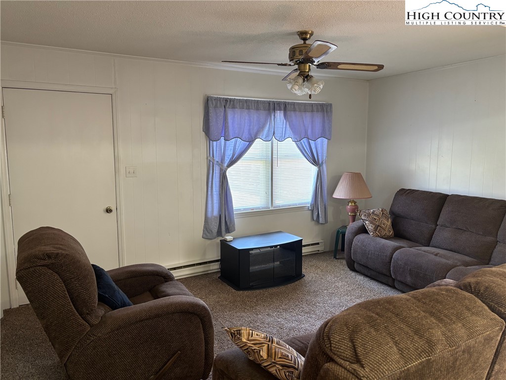 4182 Ridgeglen Road Sparta, NC 28675 - Photo 3 of 28 a living room with furniture a window and a chandelier