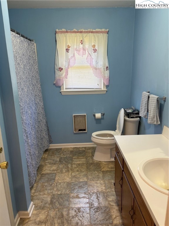4182 Ridgeglen Road Sparta, NC 28675 - Photo 9 of 28 a bathroom with a toilet sink and mirror
