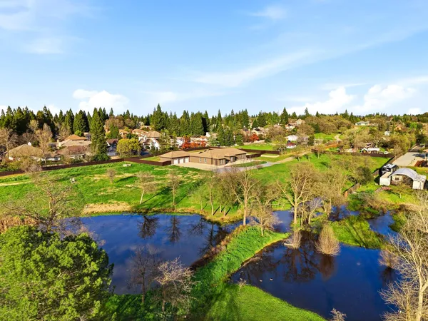 an aerial view of a houses with yard