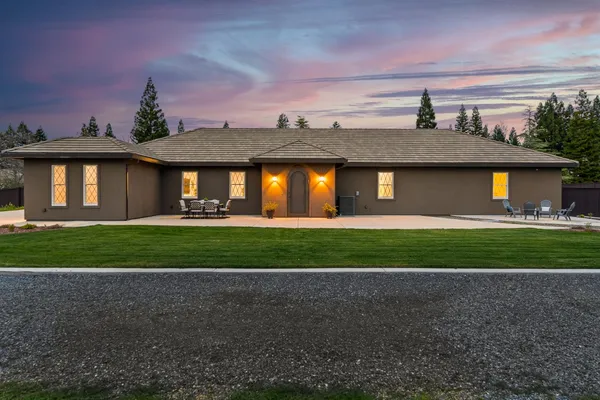 a front view of a house with a yard