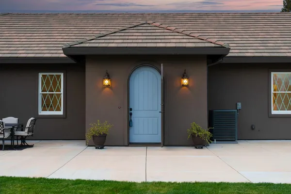 a front view of a house with a garden