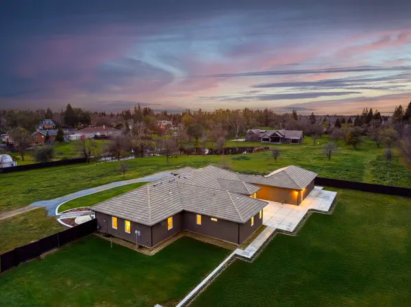 a view of a house with outdoor seating space