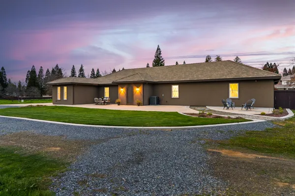 a view of a porch with a table and chairs