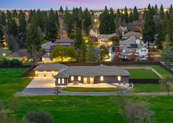 a view of a big house in front of a house with a yard