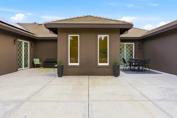 a front view of a house with a swimming pool