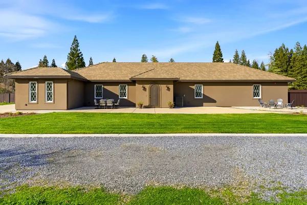 a kitchen with stainless steel appliances granite countertop a sink a stove a refrigerator and white cabinets with wooden floor