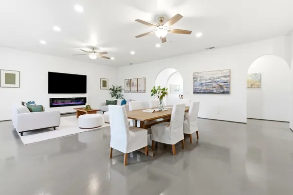 a bathroom with a granite countertop toilet sink and mirror