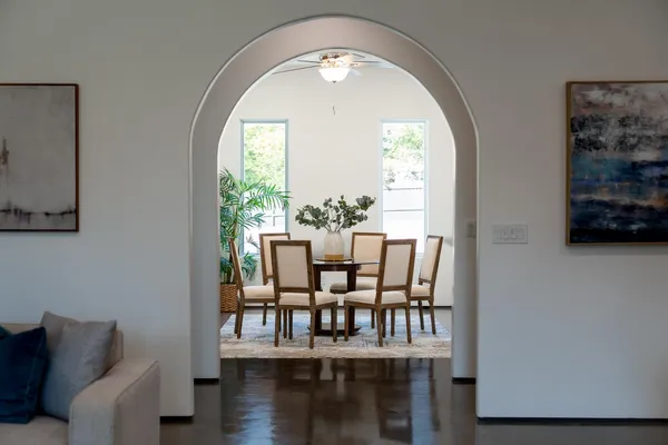 a white kitchen with sink and cabinets