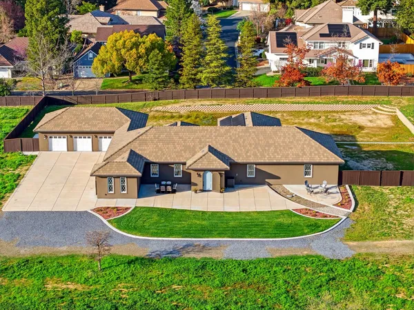 an aerial view of a house with big yard