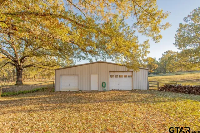 a view of a entrance gate of the house and trees