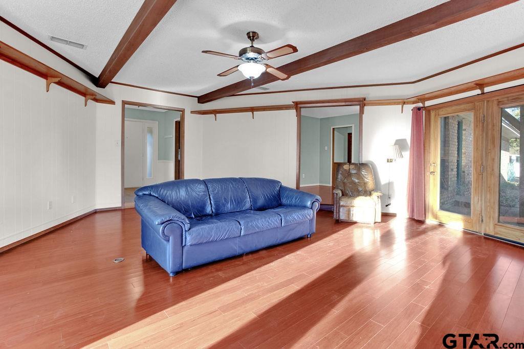 12575 FM 3271 Tyler, TX 75704 - Photo 17 of 47 a living room with couches and a ceiling fan with wooden floor