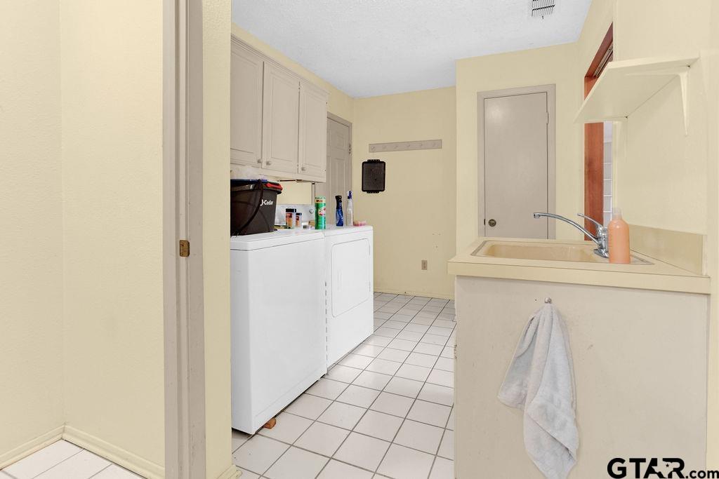 12575 FM 3271 Tyler, TX 75704 - Photo 38 of 47 a bathroom with a sink a mirror and cabinets