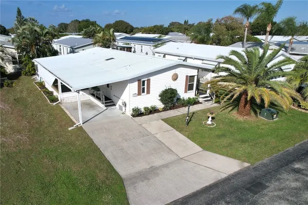 an aerial view of a house with a yard