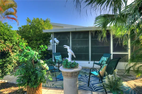a view of a chair and table in backyard of the house