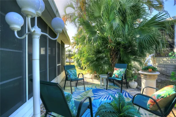 a view of a house with backyard and sitting area