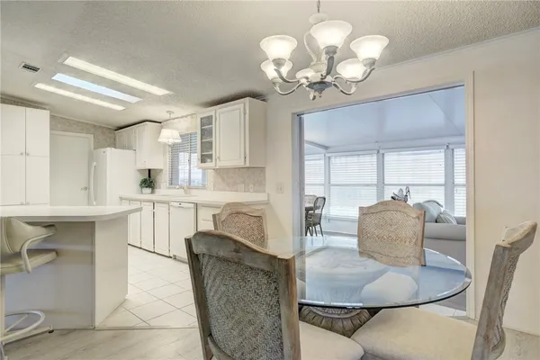 a living room with kitchen island furniture and a chandelier