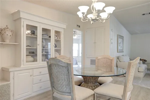 a dining room with furniture and chandelier