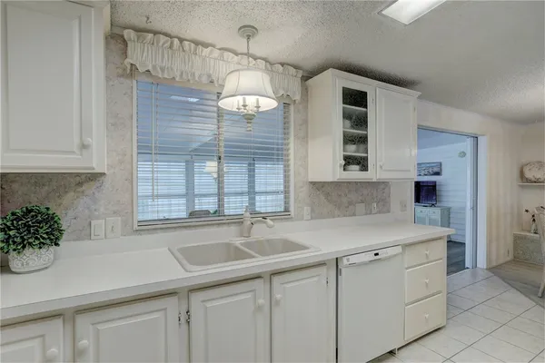 a kitchen with a sink and cabinets