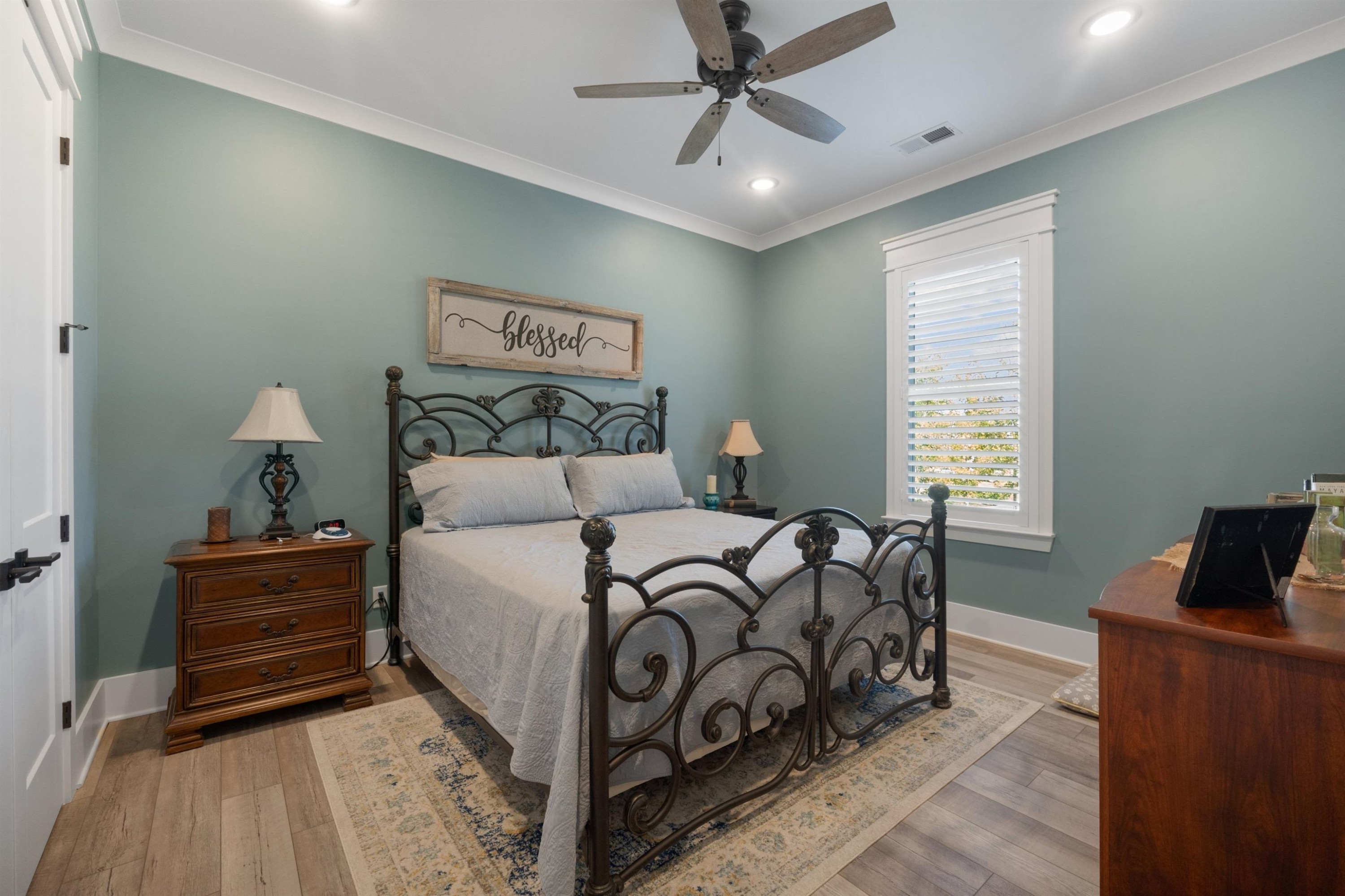 491 Cooper Anderson Road Jackson, TN 38305 - Photo 22 of 30 a spacious bedroom with a bed and wooden floor