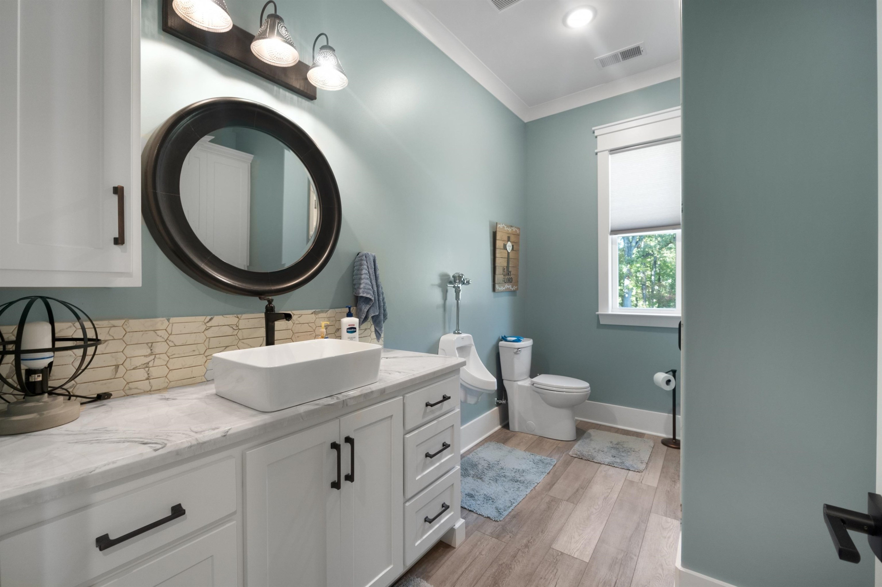 491 Cooper Anderson Road Jackson, TN 38305 - Photo 24 of 30 a bathroom with a toilet a sink and mirror